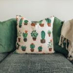 View of grey sofa with green and cactus print cushions created by upholstery Edinburgh expert.